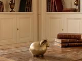 a table with books and a vase on it in a room