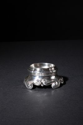 a close up of a silver ring on a black surface