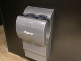 a toilet paper dispenser attached to a black wall
