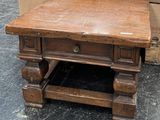 a wooden table with a drawer underneath it on the floor