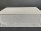 an empty white box sitting on top of a black table