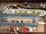 a cardboard box with a model of a boat in it