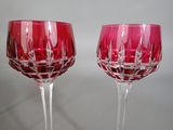 two wine glasses sitting next to each other on a table