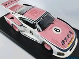 a cake shaped like a racing car on a black plate