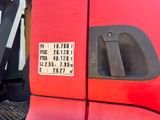 a close up of a red truck with a sign on it