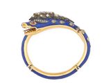 a close up of a gold ring with blue enamel and diamonds
