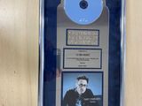a picture of a plaque with a cd on it
