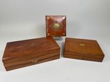 three small wooden boxes with brass decorations on them