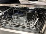 a dishwasher that has a lot of dishes inside of it