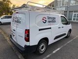 a white van that is parked in a parking lot