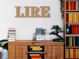 a wooden shelf with books on it in the corner of a room