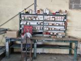 a workbench in a garage with many items on it