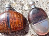 two bottles that are sitting on the ground