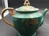 an image of a tea pot with a lid on a table