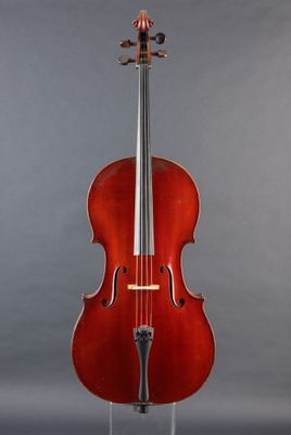 a red cello sitting on a stand against a gray background