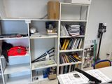 a desk with a lot of books on it in a room