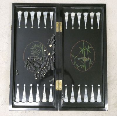 a black backgam board with white and black pieces