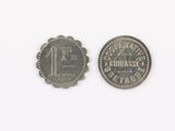 an old coin with the number one on it next to an old one