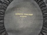 a close up of a black hat with a ribbon around it