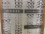 many pairs of glasses on display in a display case