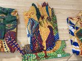 several different colored ties are hanging on a wooden surface