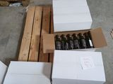 Plusieurs cartons de vin sont empilés sur une palette dans un entrepôt