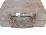 an old suitcase with a metal handle on a white surface