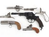 many different types of guns on display on a white surface
