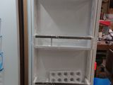 a white refrigerator with a freezer in the middle of it