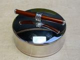 a silver box with a wooden handle and two chopsticks in it