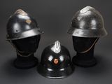 three helmets are sitting on top of each other on a black surface