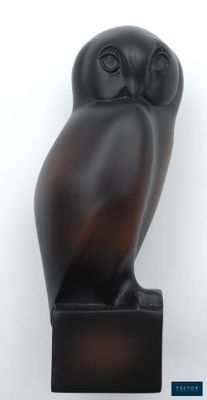 sculpture of an owl on a black base on a white background