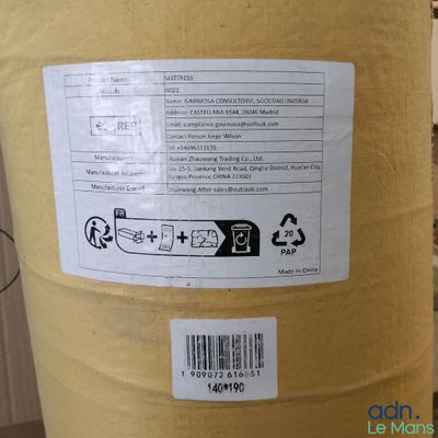 a large yellow barrel with a sticker on it