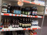 many bottles of beer on the shelves in the store