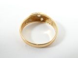 a close up of a gold ring with a diamond in it