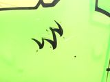 graffiti on the side of a green bus with the word w on it