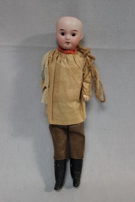 an image of a doll with brown clothes and boots on a white background