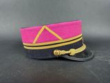 a close up of a pink and black hat on a black surface