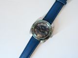 a watch that is sitting on a white table