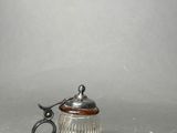 an antique silver plated tankard with a wooden handle