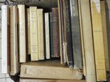 a lot of books in a box on the floor
