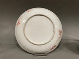 a white plate that has a red design on it