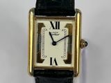 a close up of a wrist watch with roman numerals on it