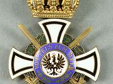 an image of a medal with a crown on top of it