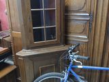 a bike that is parked in front of a cabinet