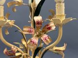 a close up of a candle holder with flowers on it