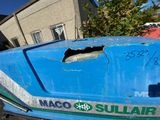 a blue boat that has a hole in the side of it