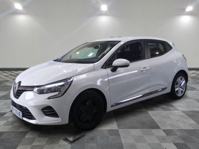 a white car parked on a checkered floor in a garage