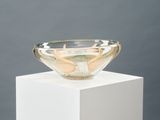 a glass bowl sitting on top of a white pedestal