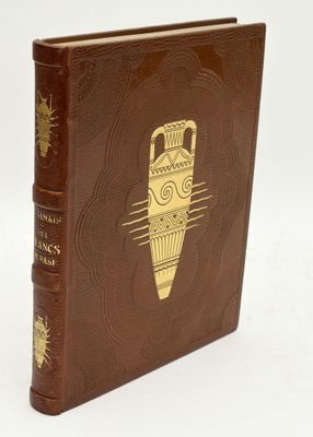an old brown book with a gold design on the cover